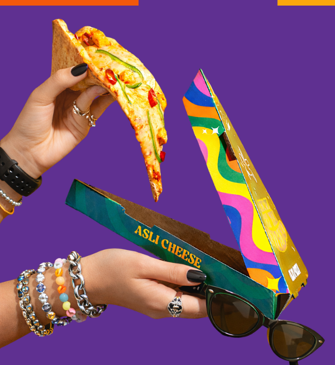A giant OLIO 99 Slice held beside its colourful triangular pack